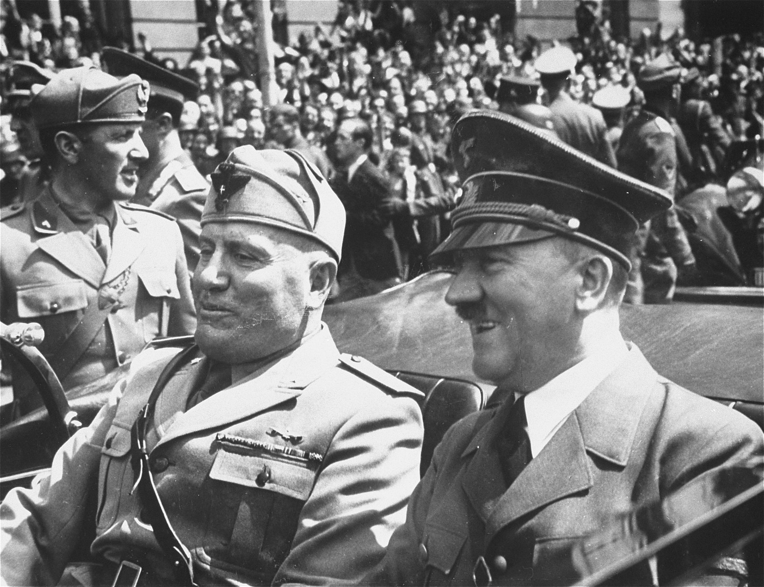 Adolf Hitler and Benito Mussolini ride a car in Munich, where they met the day after France's surrender to discuss immediate plans